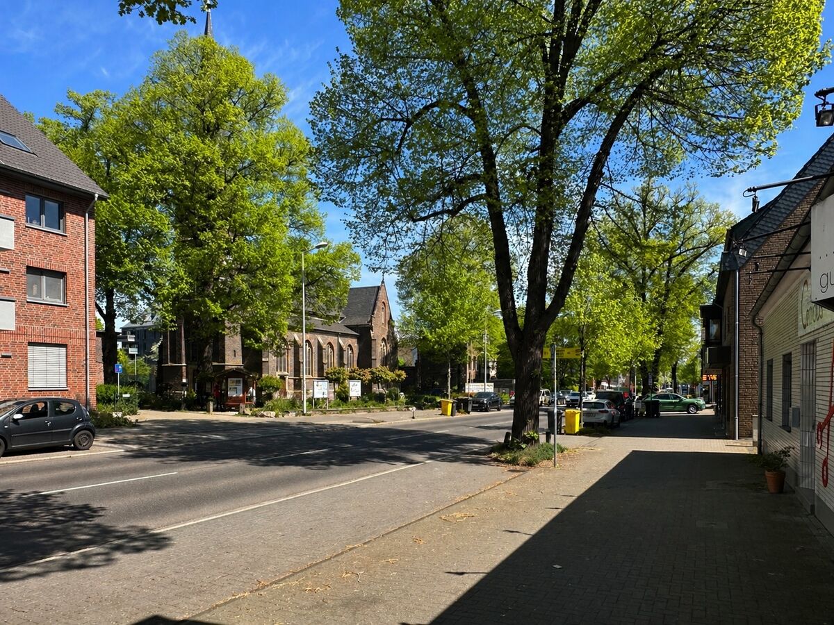 Aachener Straße in Königsdorf mit Blick auf St. Sebastianus — die Adresse, an der ETW-Spitzenpreise von rund 5.634 €/m² erzielt werden